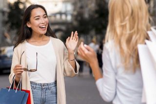 two-friends-meet-each-other-after-session-sale-shopping